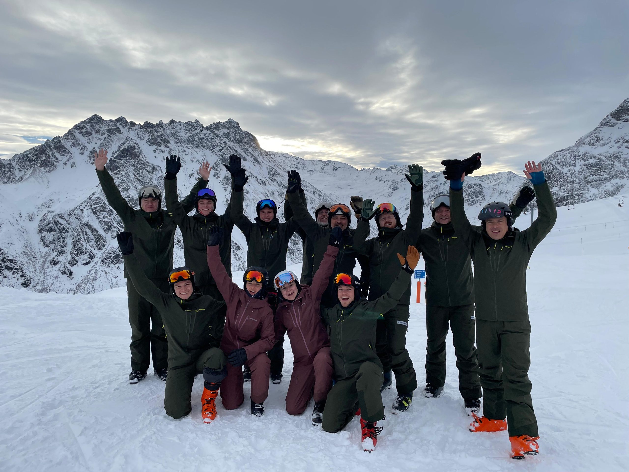 Gruppe des Skiclubs jubelt gemeinsam auf der Piste